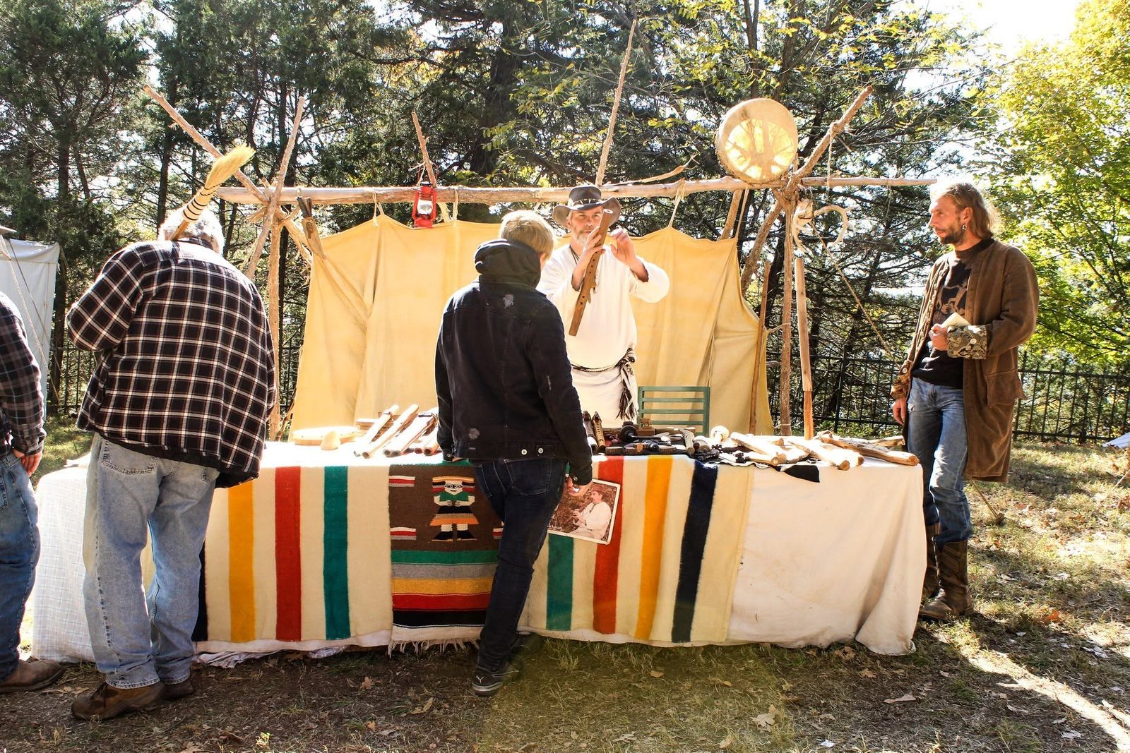 Vendors and visitors among striped blankets and tents at Pioneer Heritage Days